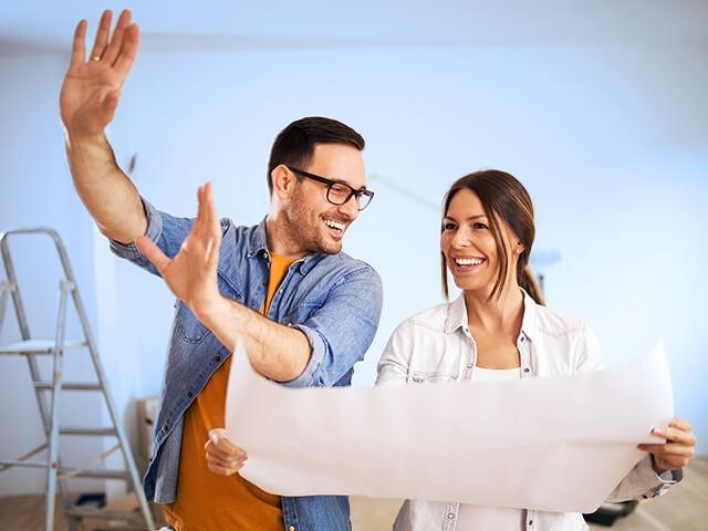 A husband and wife review remodeling plans.