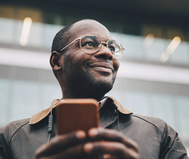 Man with mobile phone smiling