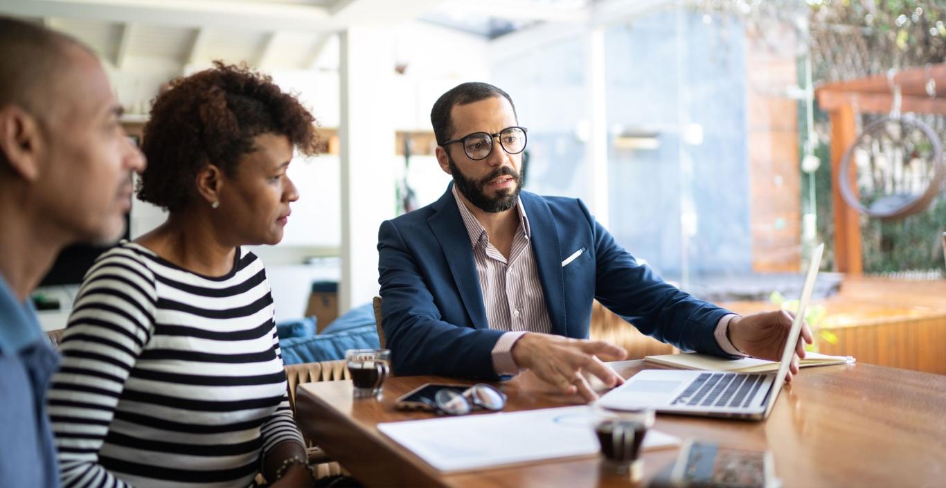 Man working on laptop with woman