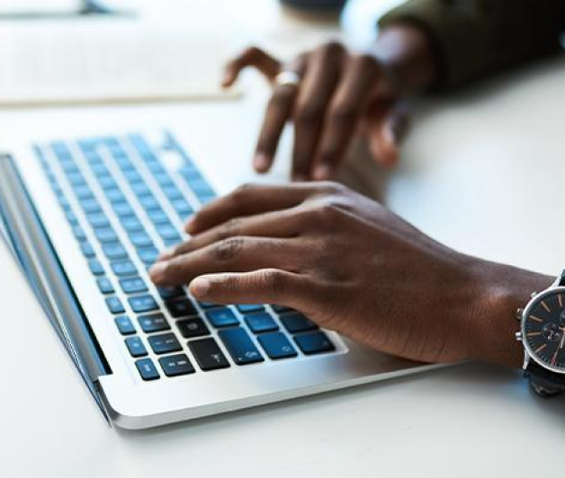 Hands on a laptop keyboard typing