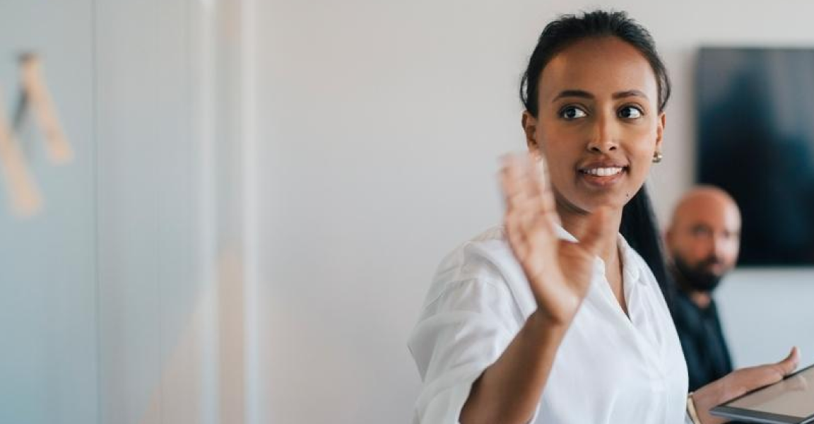 Woman waving her hand in an office