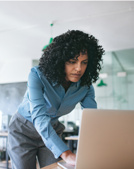 A woman works on a laptop from home