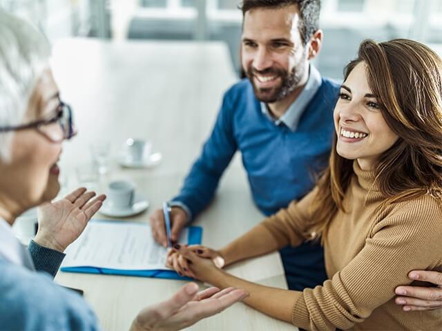 husband and wife at home speaking with financial advisor